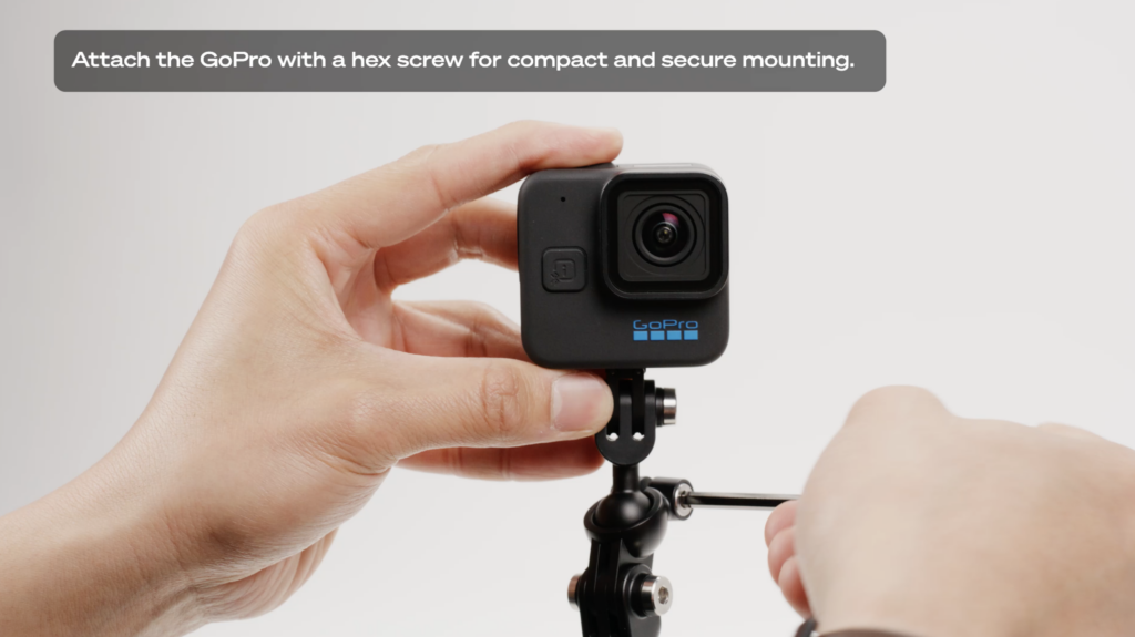 Hands tightening hex screw connecting the GoPro Boom to the GoPro Hero11 Mini Hero 11 mini tutorial educational video GoPro Tips