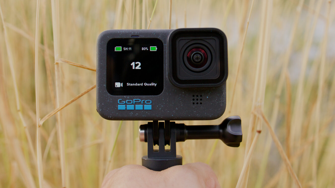 Hand holding a GoPro Hero 12 Black with camera facing the viewer. Selfie shot using GoPro