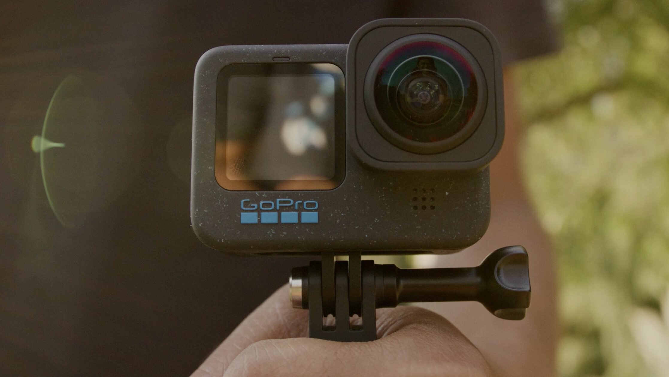 Hand holding GoPro Hero 12 black with Max Lens Mod 2.0 installed