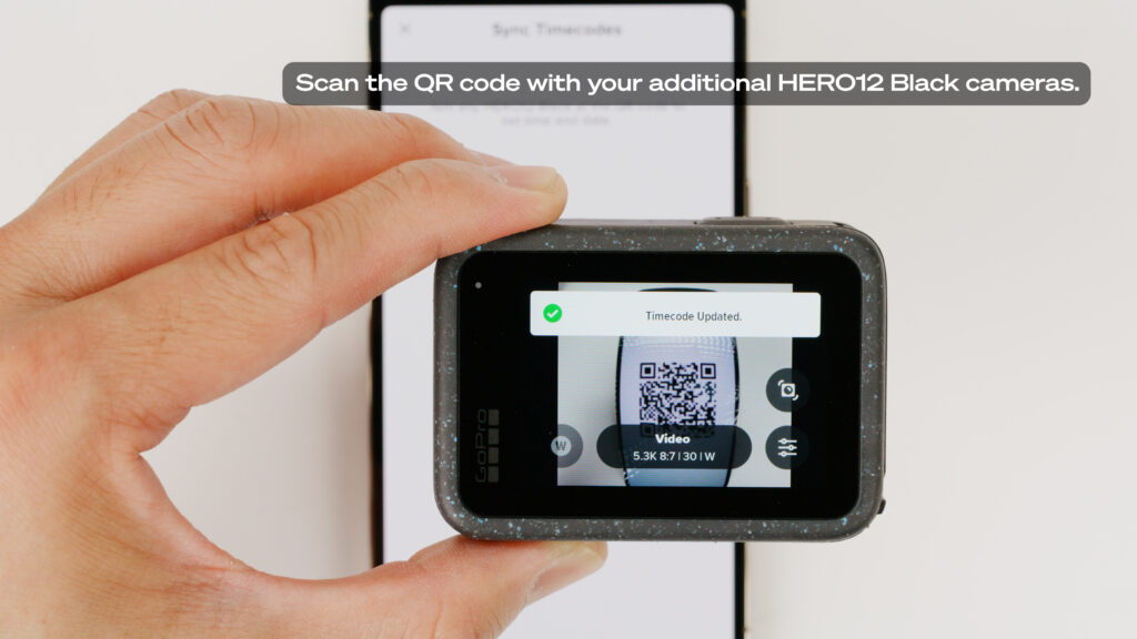 GoPro Hero 12 Black rear screen showing QR code being scanned to enable timecode sync between multiple GoPro cameras. Video Production workflow masked post production more efficient