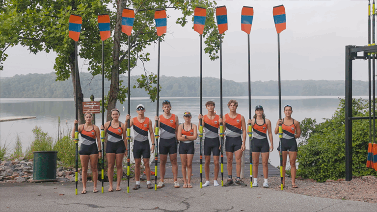 Triangle Rowing Club Team hold Oars by the dock. Video Production from Full Circle Streaming & Digital