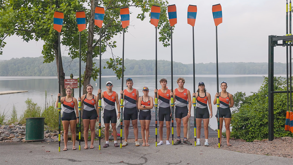 Triangle Rowing Club Team hold Oars by the dock. Video Production from Full Circle Streaming & Digital